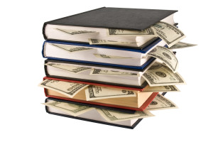 bigstock-Dollars-in-the-books-4201911